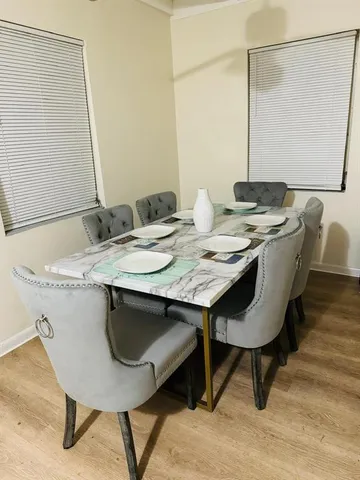a dining table with a sink and a mirror