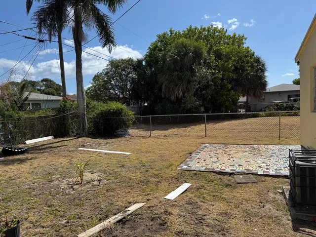 a bedroom with a bed window and a table
