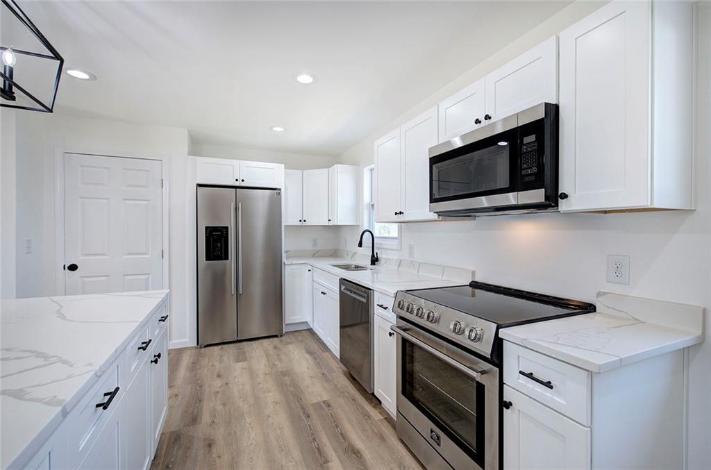 516 Baxter Road Southeast Calhoun, GA 30701 - Photo 15 of 47 a kitchen with a sink stove and refrigerator