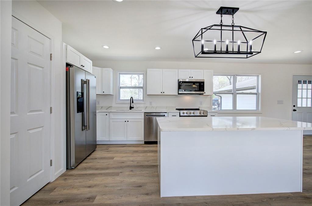 516 Baxter Road Southeast Calhoun, GA 30701 - Photo 17 of 47 a kitchen with stainless steel appliances a refrigerator and a stove top oven