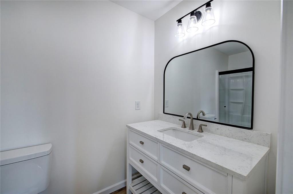 516 Baxter Road Southeast Calhoun, GA 30701 - Photo 27 of 47 a bathroom with a sink vanity and a mirror