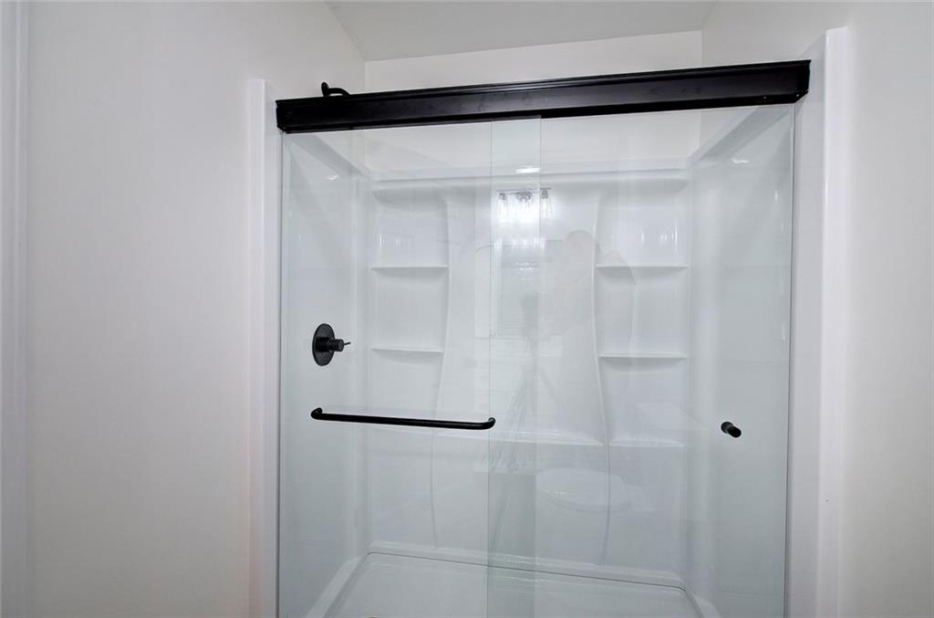 516 Baxter Road Southeast Calhoun, GA 30701 - Photo 28 of 47 a bathroom with a glass shower door