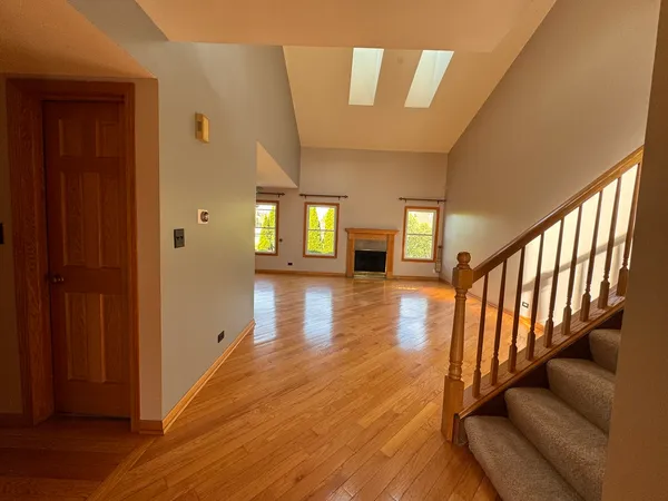 a view of entryway and hall with wooden floor