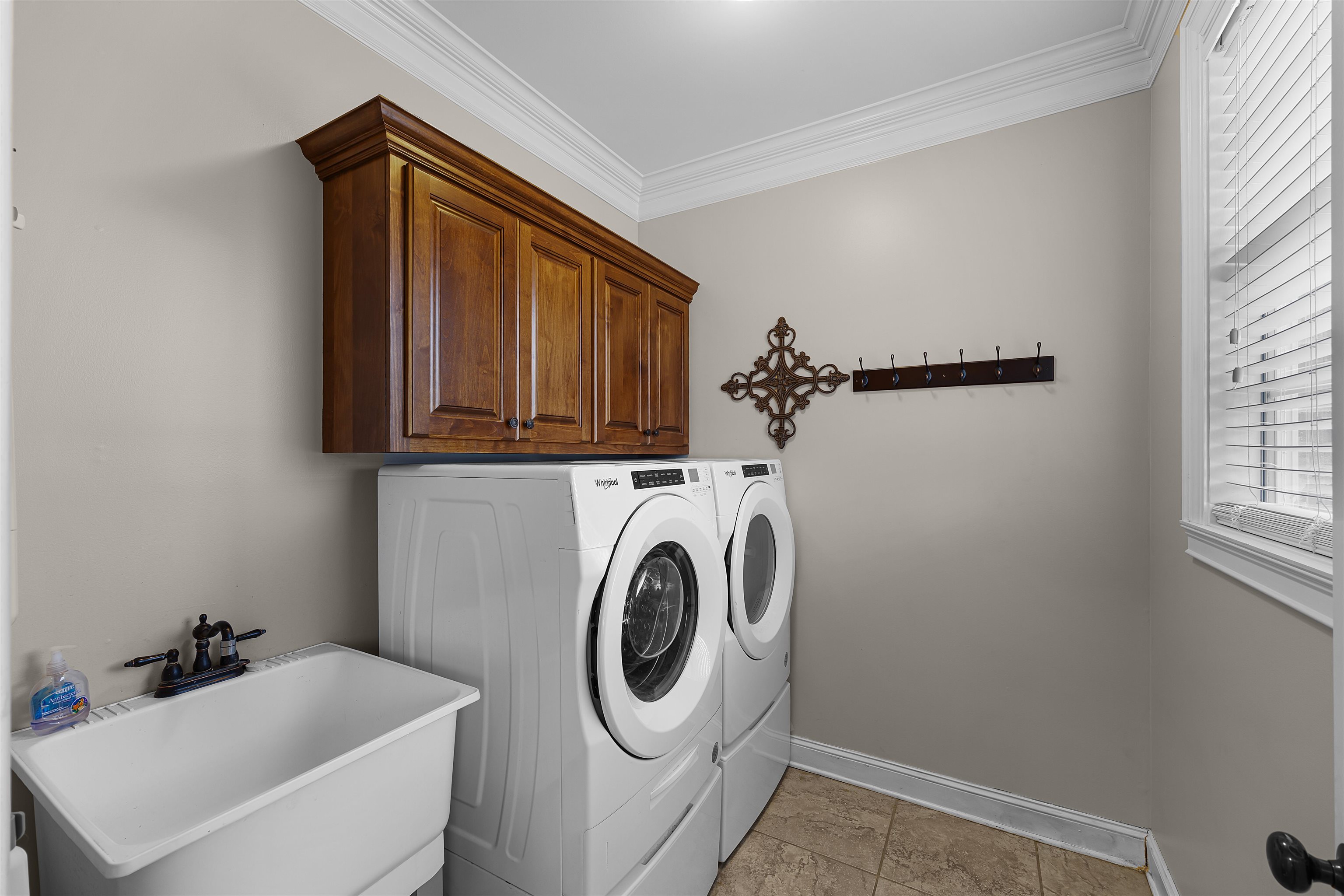 3285 Shadowood Lane Corinth, MS 38834 - Photo 19 of 30 Laundry room featuring washer and dryer, cabinet space, and ornamental molding