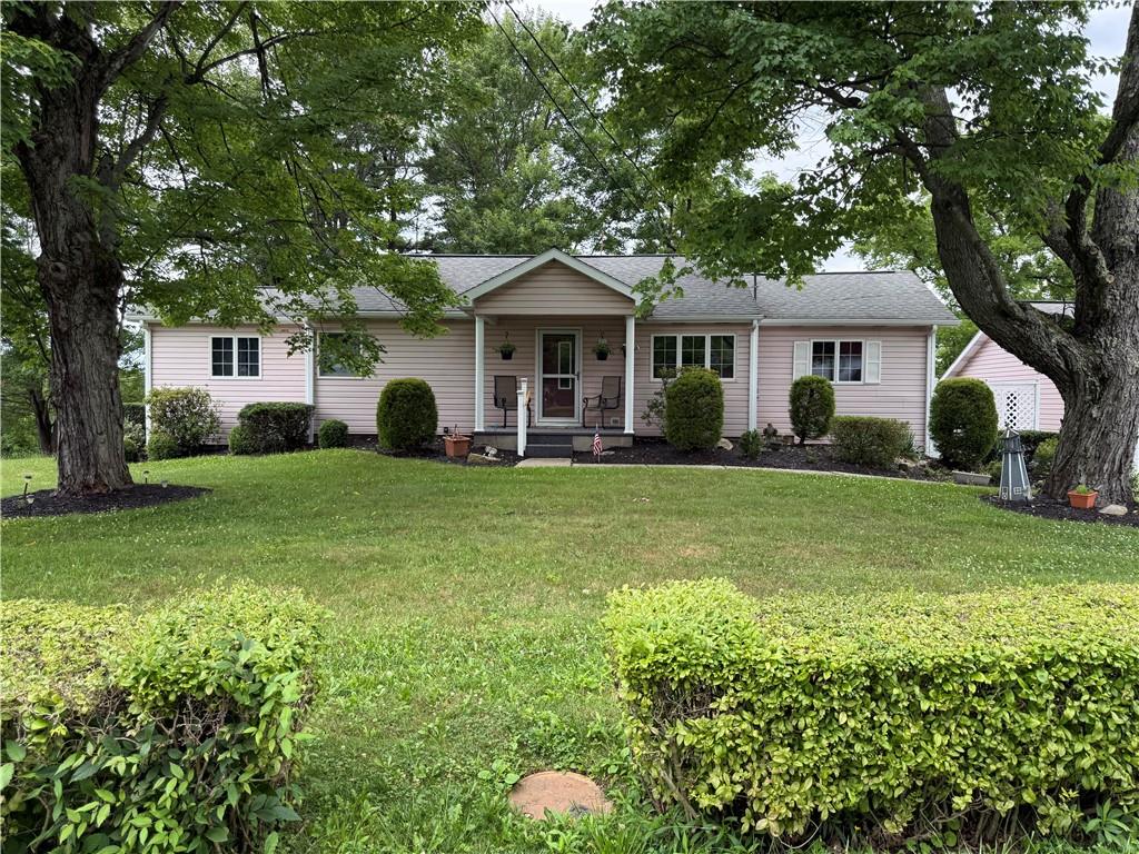 Beautiful home with lush landscaping and mature trees.