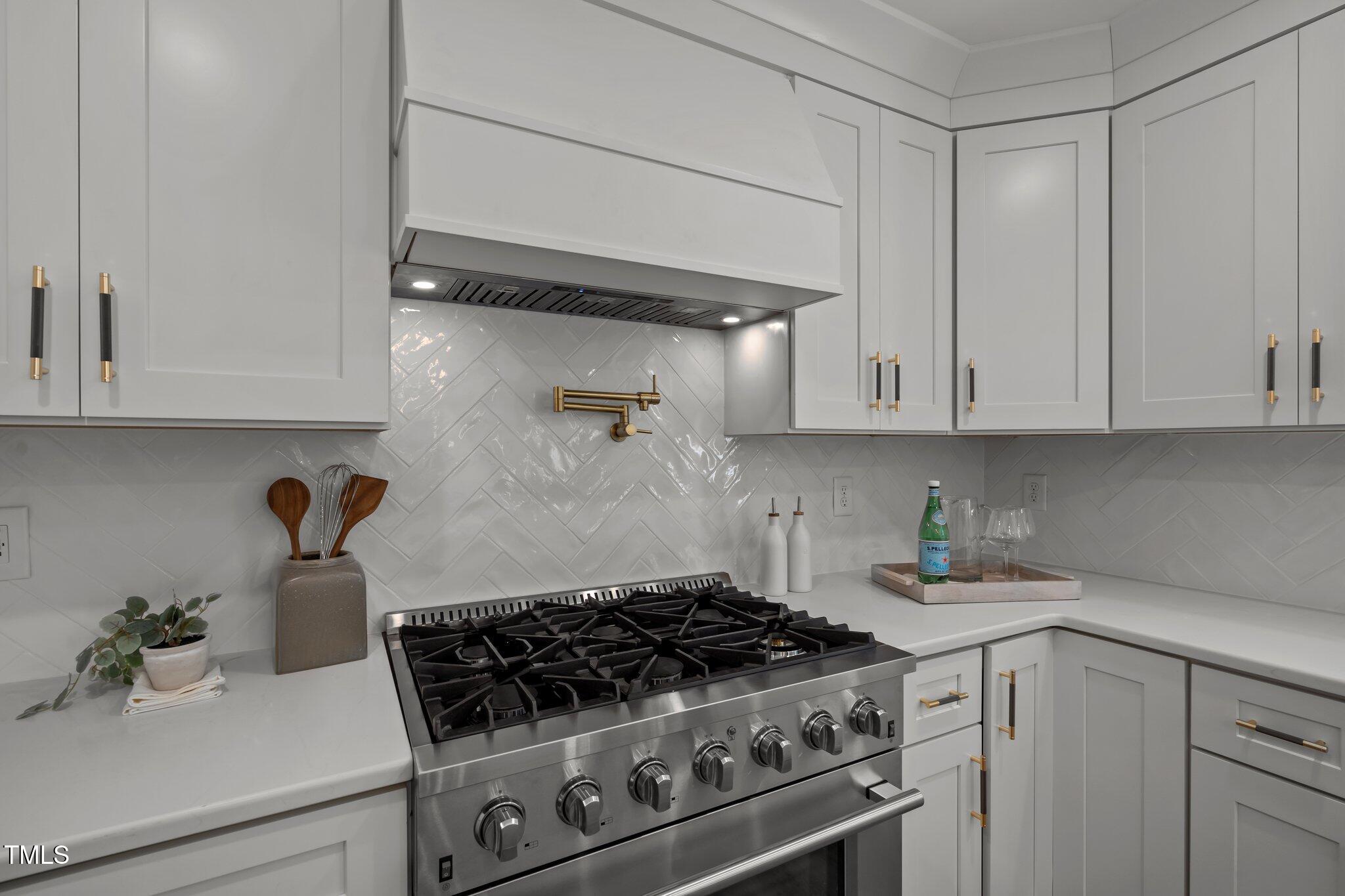 2801 Ashland Street Raleigh, NC 27608 - Photo 13 of 44 a kitchen with white cabinets and appliances