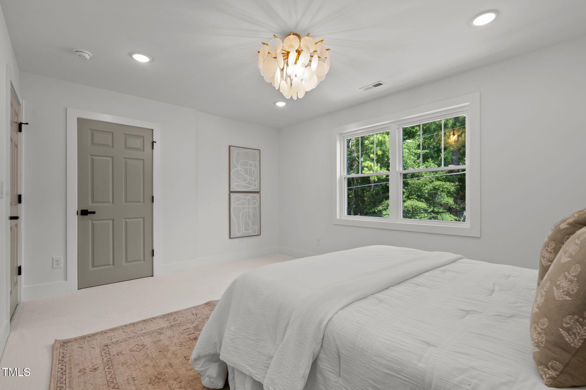 2801 Ashland Street Raleigh, NC 27608 - Photo 18 of 44 a bedroom with a chandelier and a chandelier