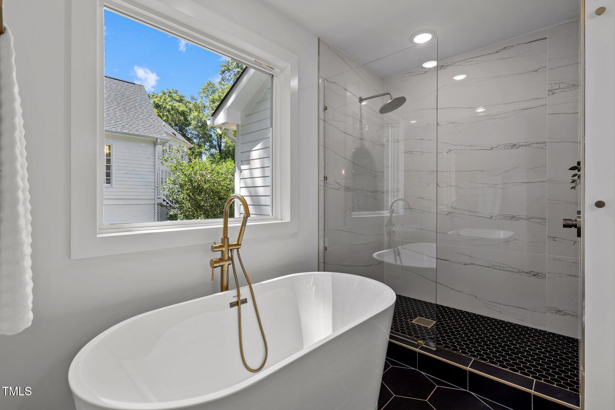 2801 Ashland Street Raleigh, NC 27608 - Photo 20 of 44 a bathroom with a sink and a bathtub