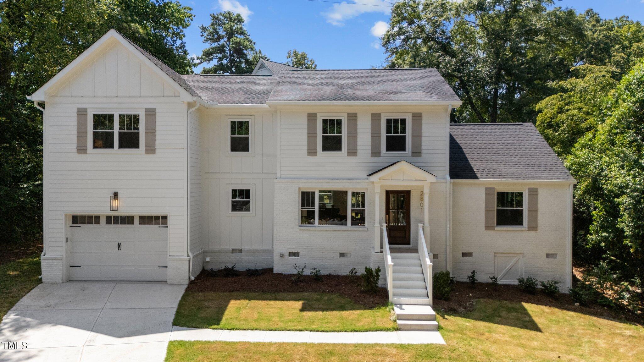 2801 Ashland Street Raleigh, NC 27608 - Photo 2 of 44 a view of a white house with a small yard plants and large tree