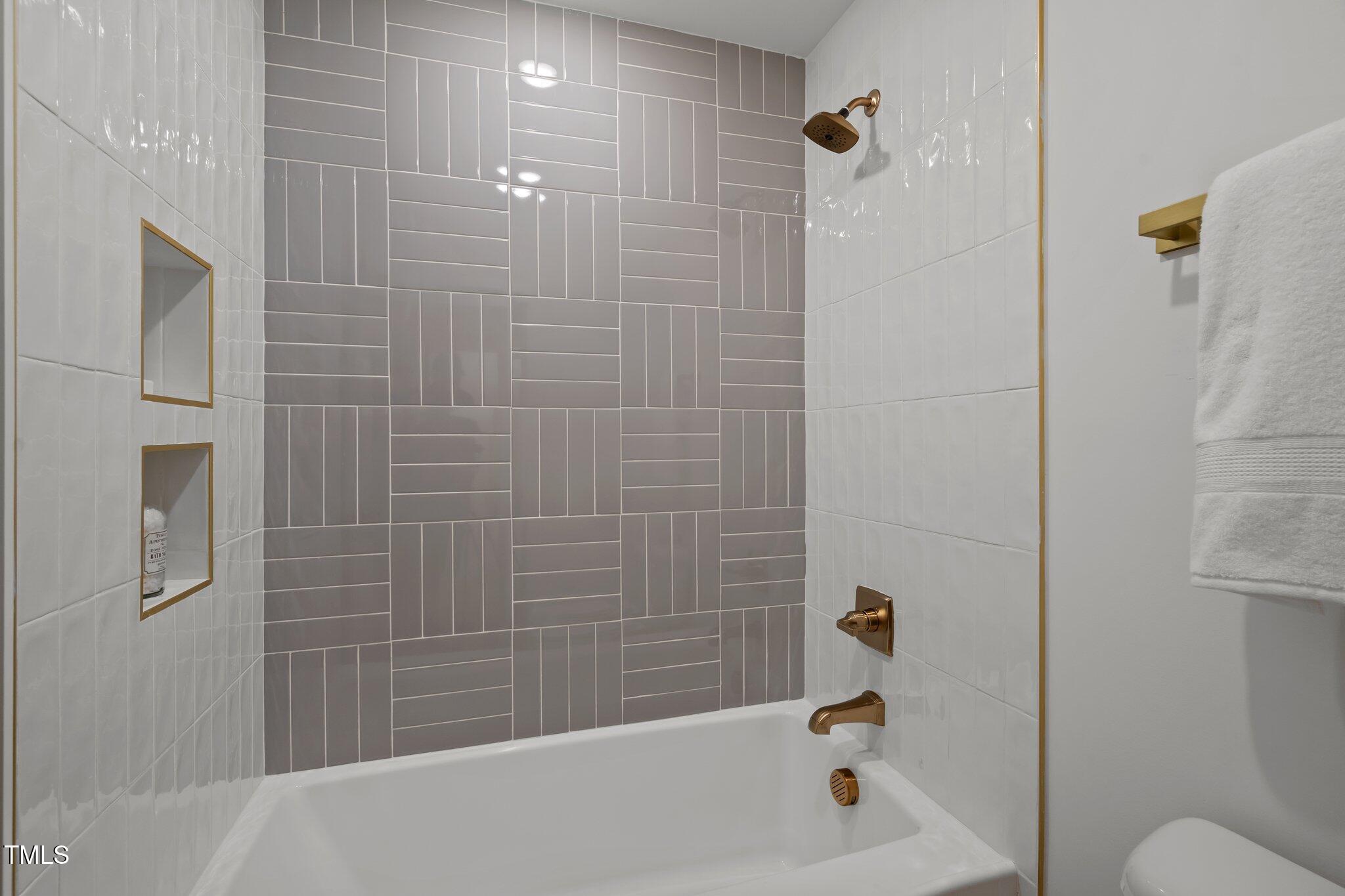 2801 Ashland Street Raleigh, NC 27608 - Photo 27 of 44 a bathroom with a bathtub and a shower