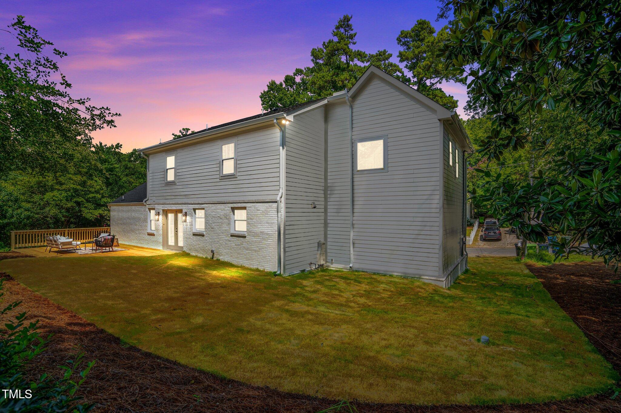 2801 Ashland Street Raleigh, NC 27608 - Photo 35 of 44 a front view of house with yard and trees in the background