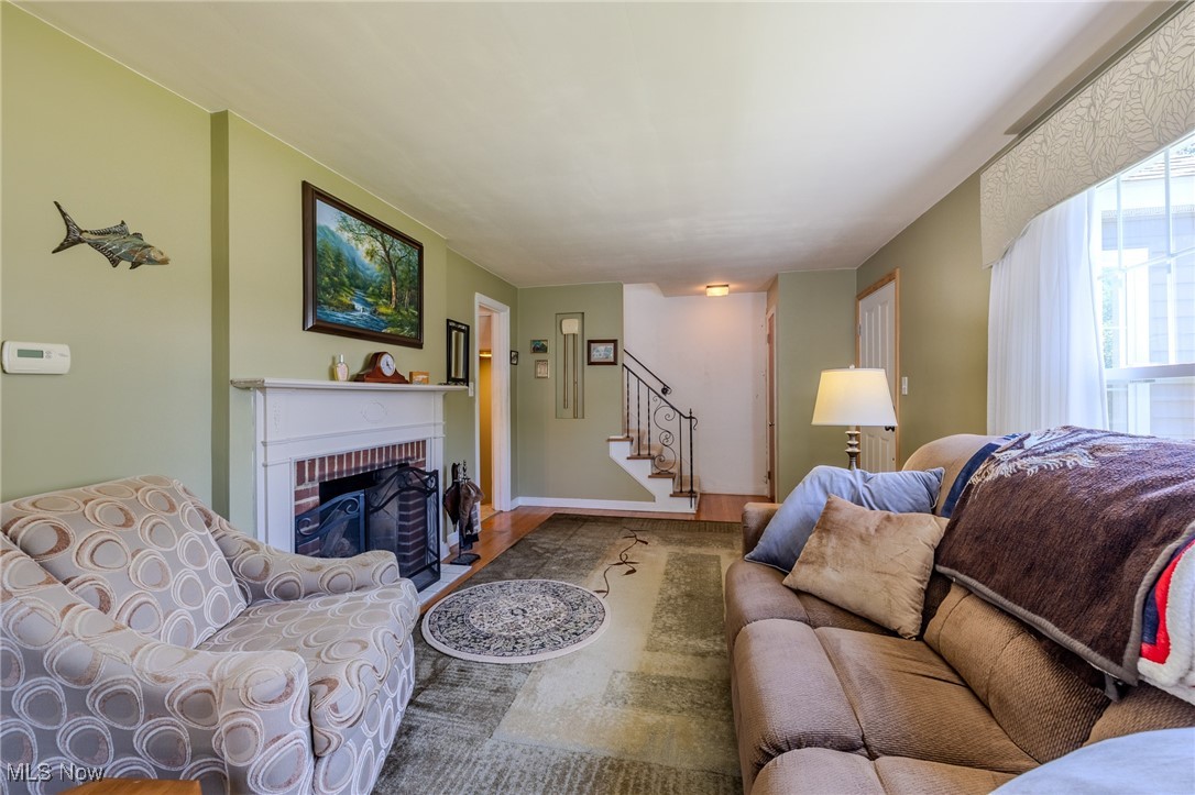 4959 Anderson Road Cleveland, OH 44124 - Photo 27 of 43 Living area featuring wood finished floors, stairs, and a fireplace
