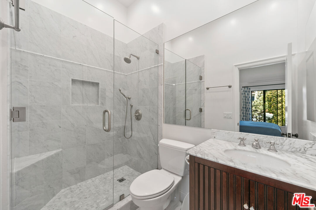 6801 Shearwater Lane Malibu, CA 90265 - Photo 16 of 33 a bathroom with a granite countertop sink toilet a shower and a bathtub