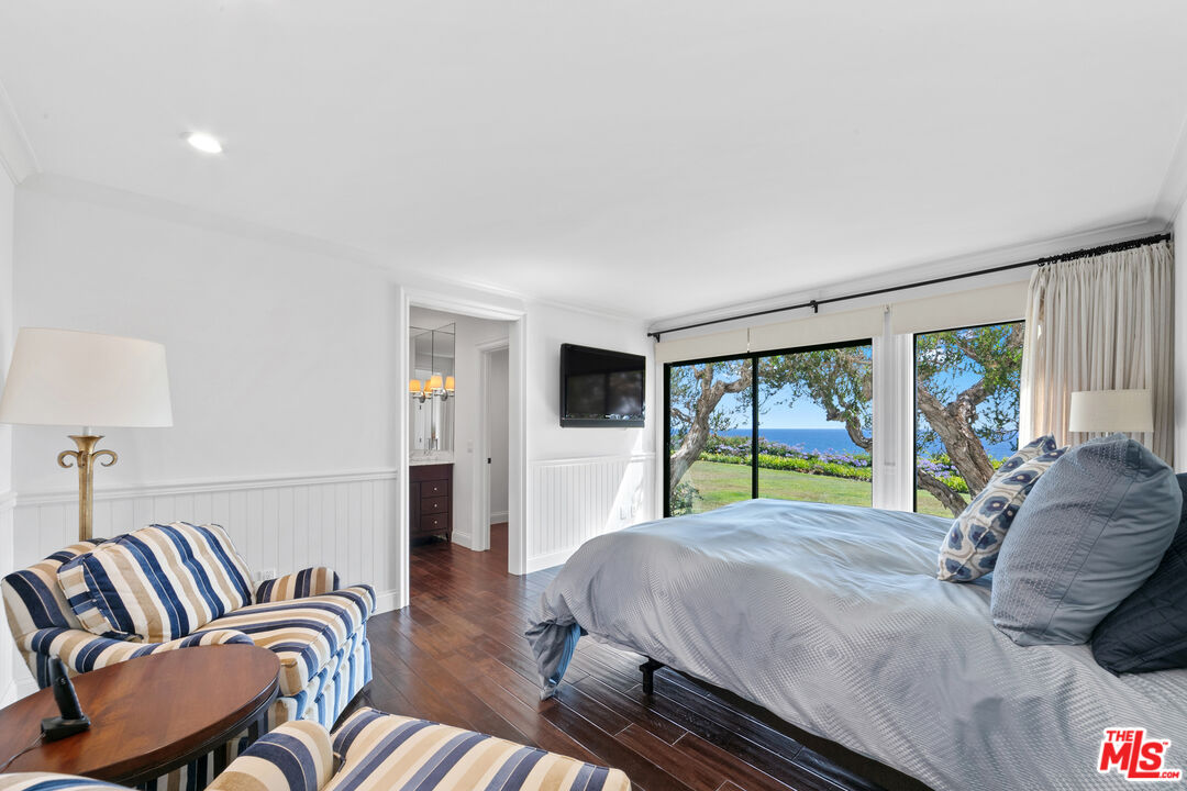 6801 Shearwater Lane Malibu, CA 90265 - Photo 19 of 33 a bed room with a bed and a chair