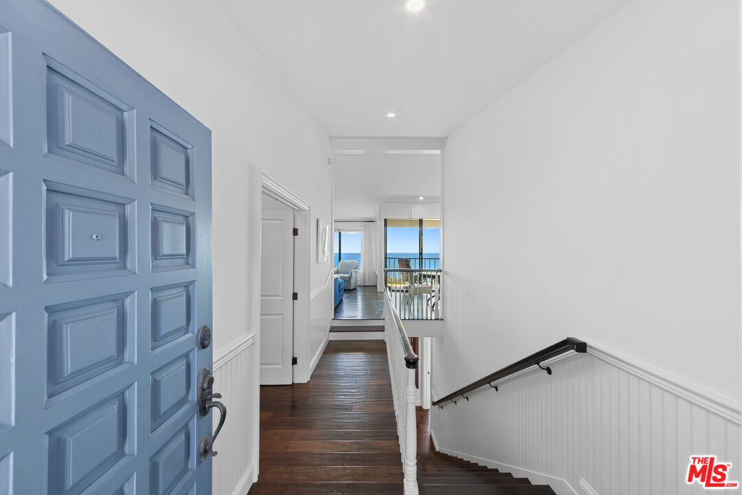 6801 Shearwater Lane Malibu, CA 90265 - Photo 6 of 33 a view of a hallway with a hardwood floor and stairs
