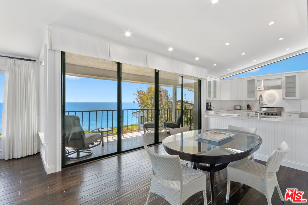 6801 Shearwater Lane Malibu, CA 90265 - Photo 10 of 33 a view of a dining room with furniture window and wooden floor