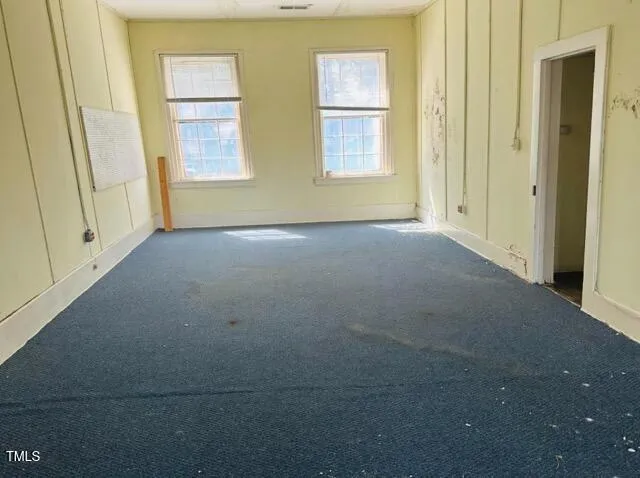 a view of empty room with windows
