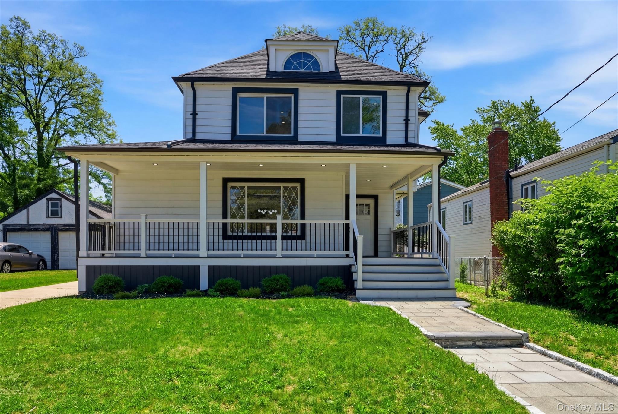 135 Whaley Street Freeport, NY 11520 - Photo 4 of 38 a front view of a house with garden