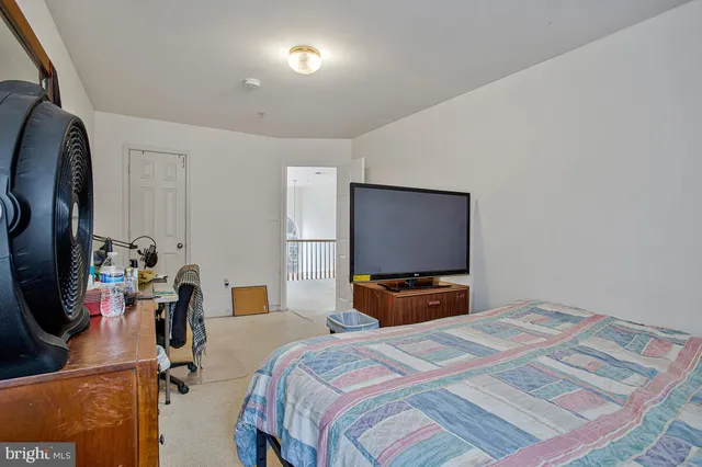 a bathroom with a tub a sink and a large mirror