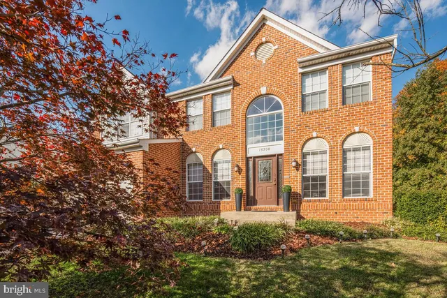 a front view of a house with lots of yellow lighting
