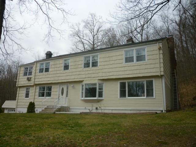 7 North Shore Drive Ridgefield, CT 06877 - Photo 1 of 1 a front view of a house with a garden