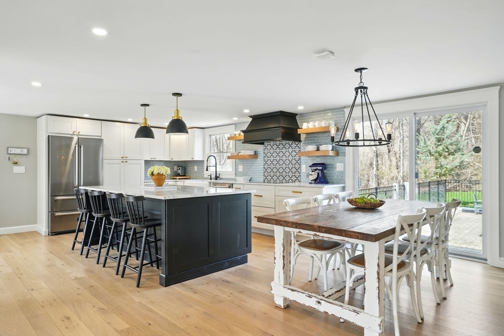11 Old Oaken Bucket Road Norwell, MA 02061 - Photo 12 of 39 a kitchen with stainless steel appliances granite countertop a dining table chairs and white cabinets