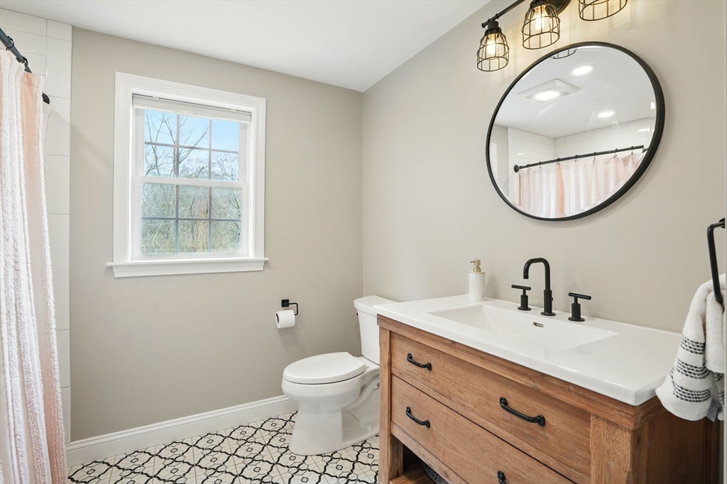 11 Old Oaken Bucket Road Norwell, MA 02061 - Photo 18 of 39 a bathroom with a toilet a sink a vanity and a mirror
