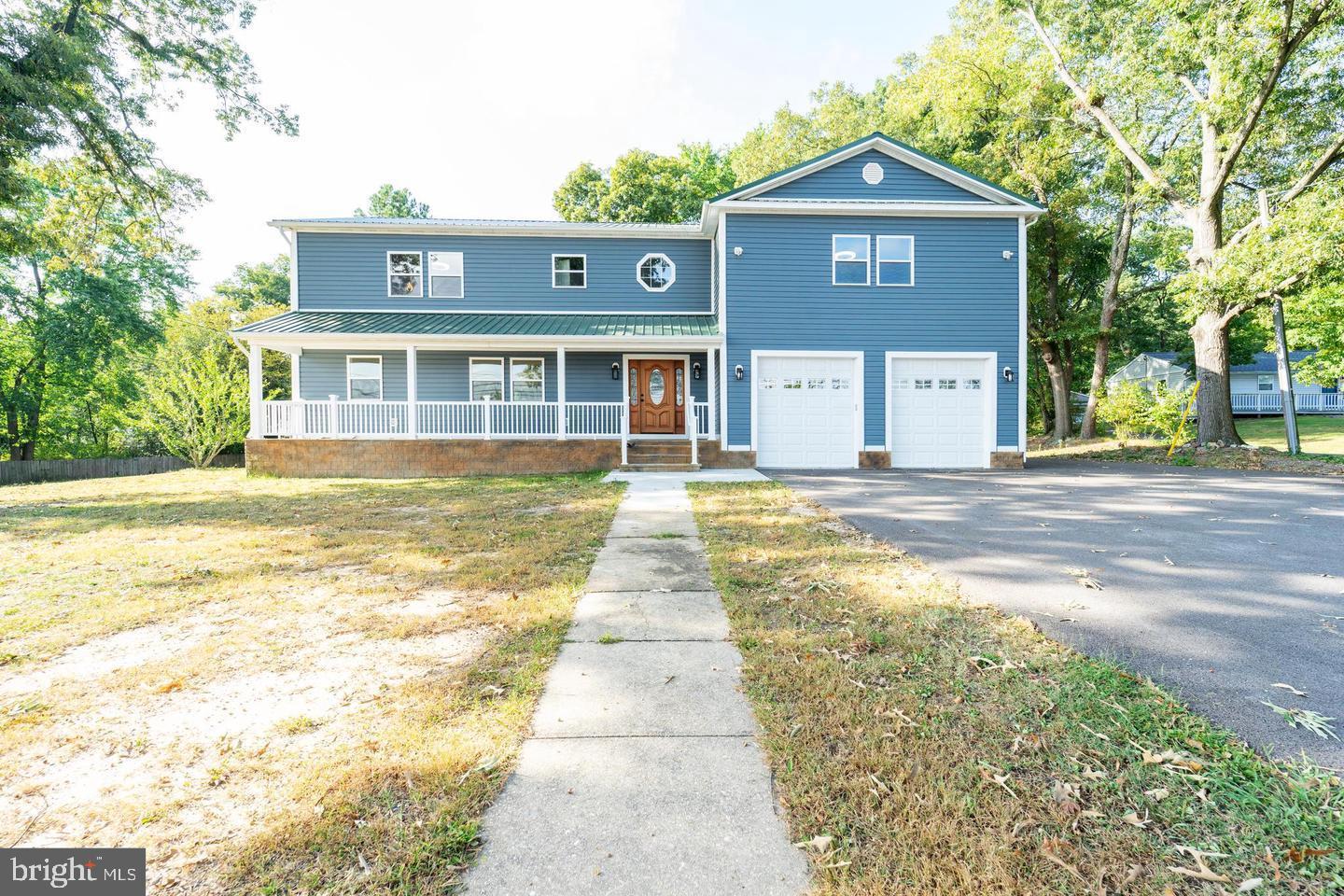 1123 Odenton Road Odenton, MD 21113 - Photo 1 of 22 a front view of a house with a yard and garage