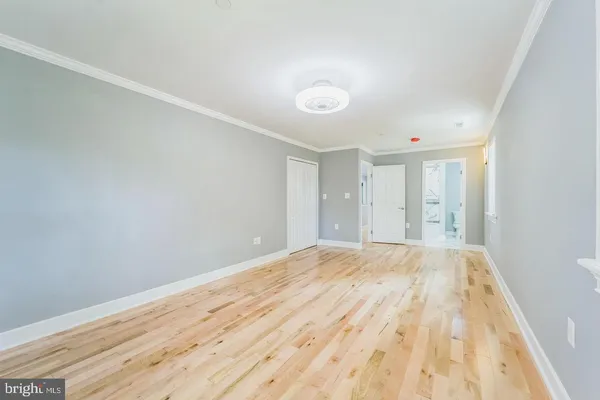 a view of an empty room and wooden floor