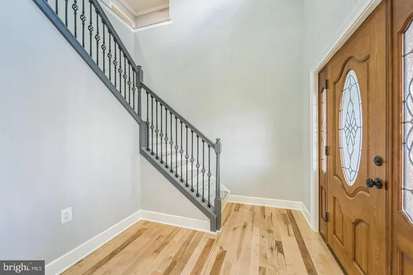 a view of a hallway with wooden floor and entryway