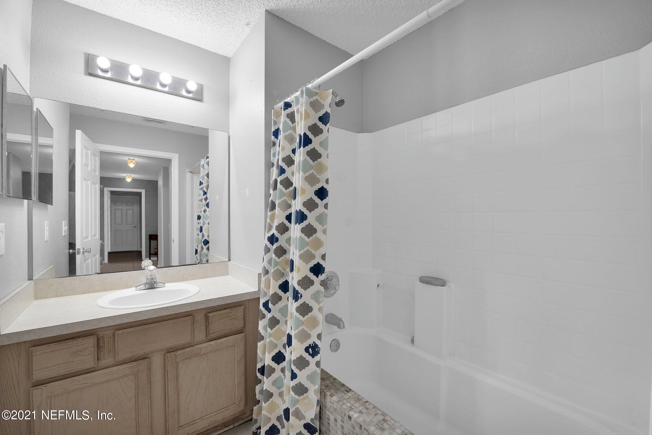 2603 Springwillow Drive Jacksonville, FL 32221 - Photo 23 of 30 a bathroom with a sink and a mirror
