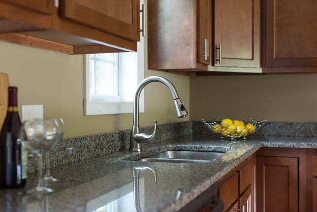 292 East Riverside Drive Timberville, VA 22853 - Photo 6 of 29 A closer look at the granite counters and gooseneck faucet over the double basin stainless sink.