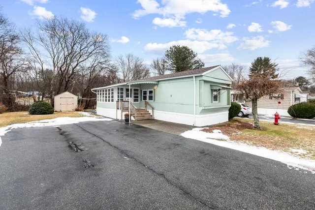 a view of a house with a yard covered in snow