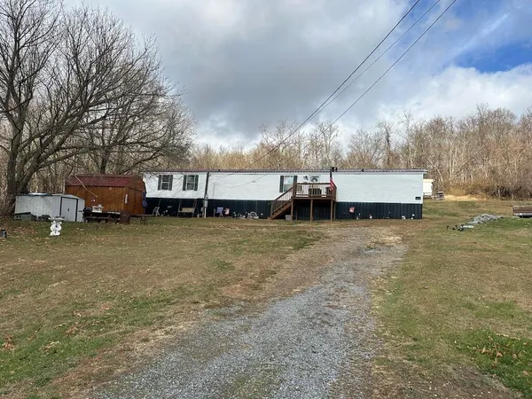 a view of a house with a yard and sitting area