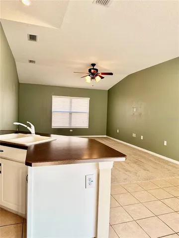 a kitchen with a sink and a stove top oven
