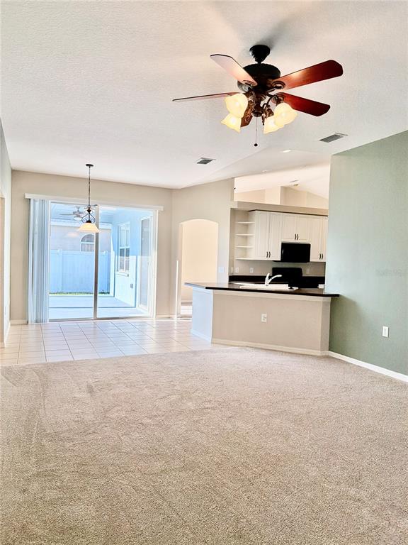 31224 Crestmont Court Wesley Chapel, FL 33543 - Photo 24 of 36 a view of a kitchen with a sink and a refrigerator