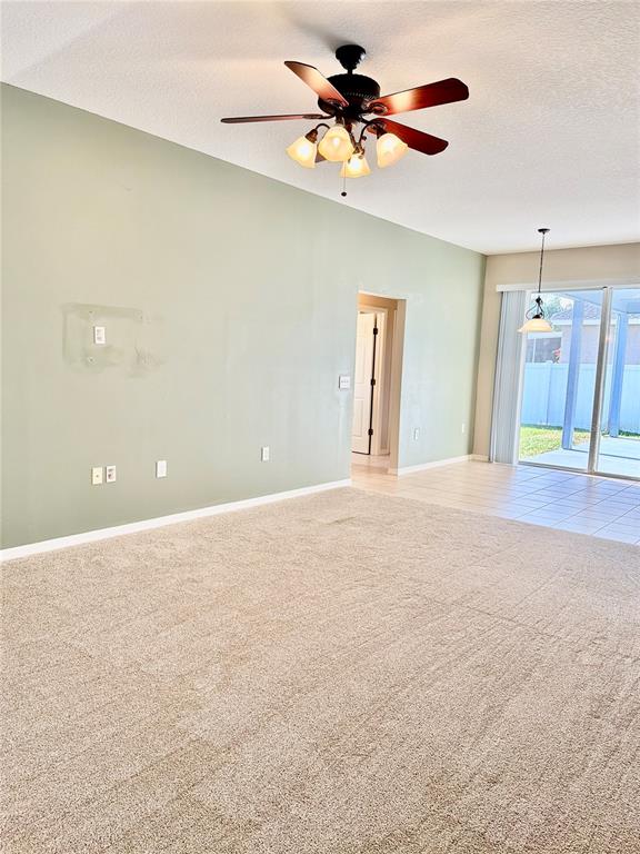 31224 Crestmont Court Wesley Chapel, FL 33543 - Photo 27 of 36 a view of a big room with a ceiling fan and a chandelier fan