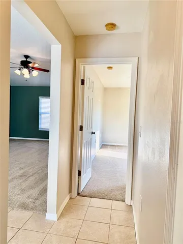 a view of a hallway to rooms