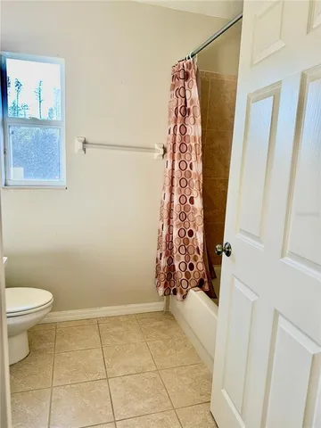 a bathroom with a toilet and shower