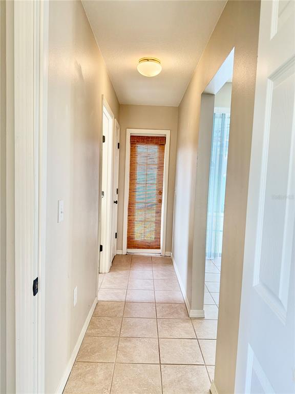 31224 Crestmont Court Wesley Chapel, FL 33543 - Photo 32 of 36 a view of a hallway with wooden floor and a bathroom