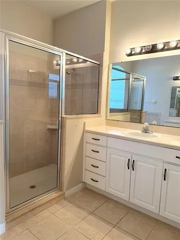 a bathroom with a shower sink and mirror