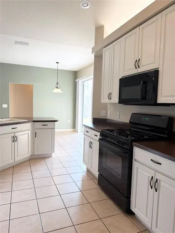 a kitchen with stainless steel appliances a stove a sink and a microwave