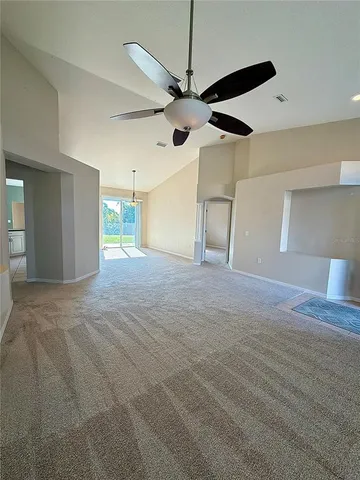 a view of a livingroom with a ceiling fan and window
