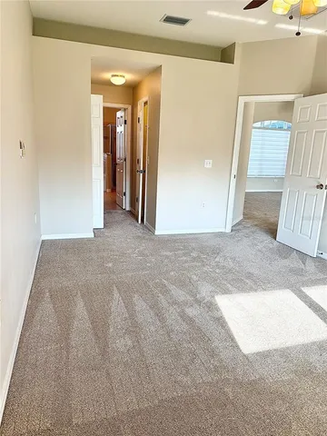 a view of a hallway with wooden floor and entryway