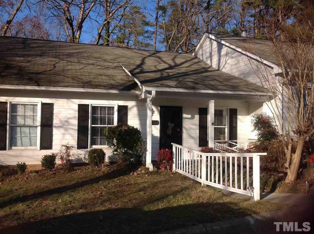 a view of a house with a wooden fence