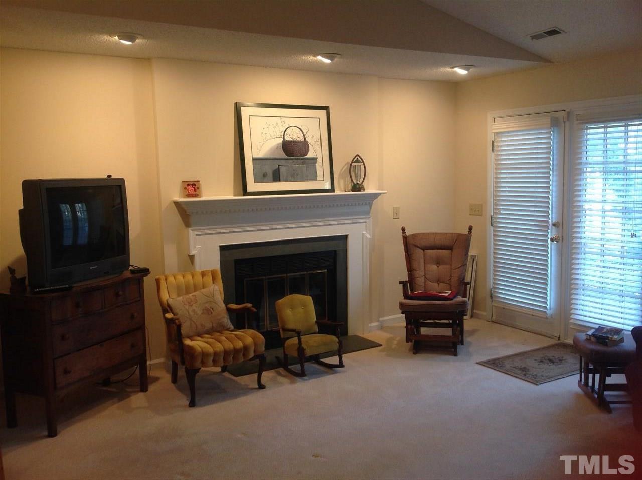 2632 Cottage Circle Raleigh, NC 27613 - Photo 3 of 10 a living room with furniture a window and a fireplace