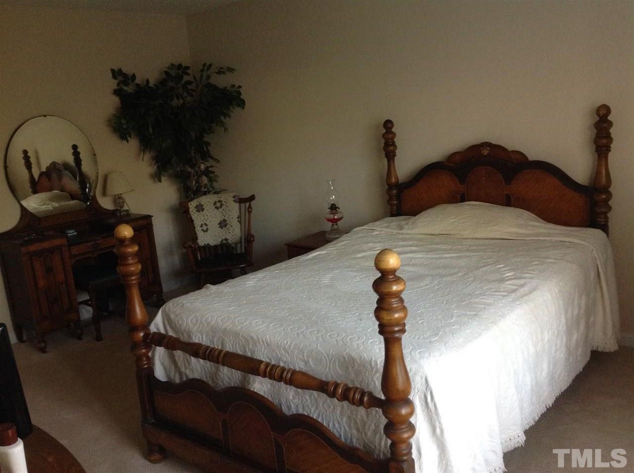 2632 Cottage Circle Raleigh, NC 27613 - Photo 7 of 10 a bedroom with a bed and a dresser