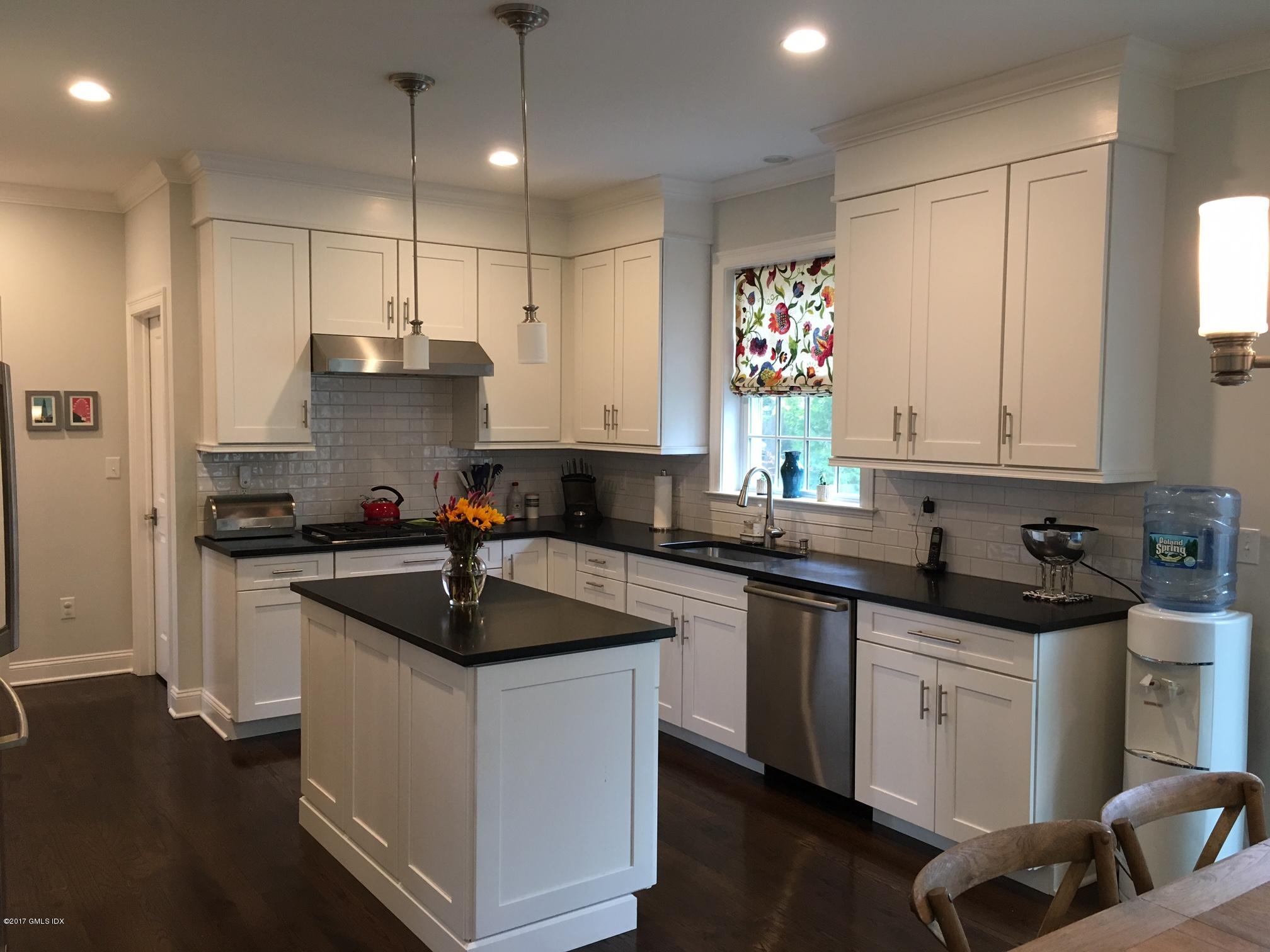 551 River Road Cos Cob, CT 06870 - Photo 12 of 40 a kitchen with granite countertop a sink stainless steel appliances and cabinets