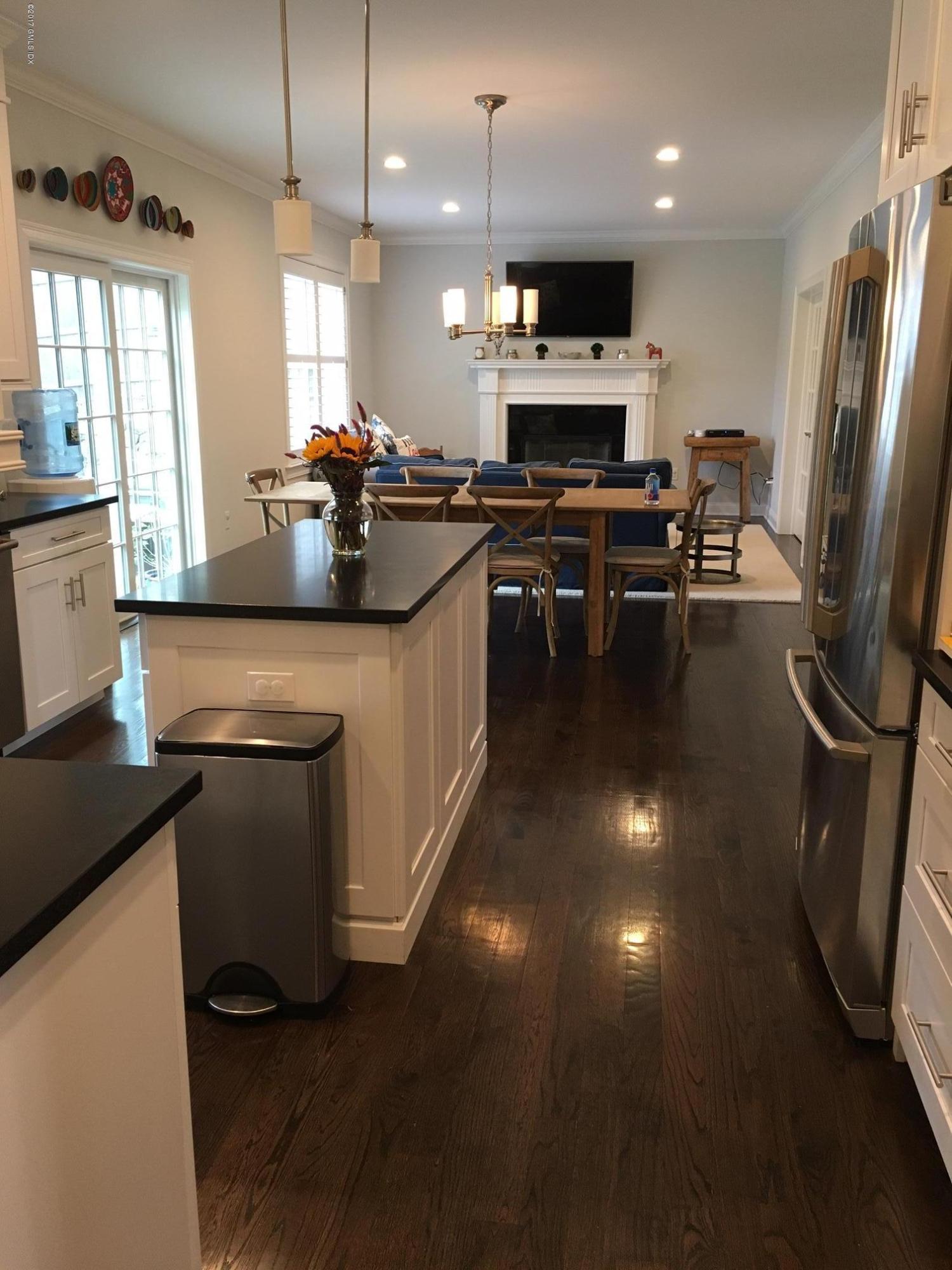 551 River Road Cos Cob, CT 06870 - Photo 13 of 40 a kitchen with stainless steel appliances a sink a stove a microwave a refrigerator cabinets and living room view