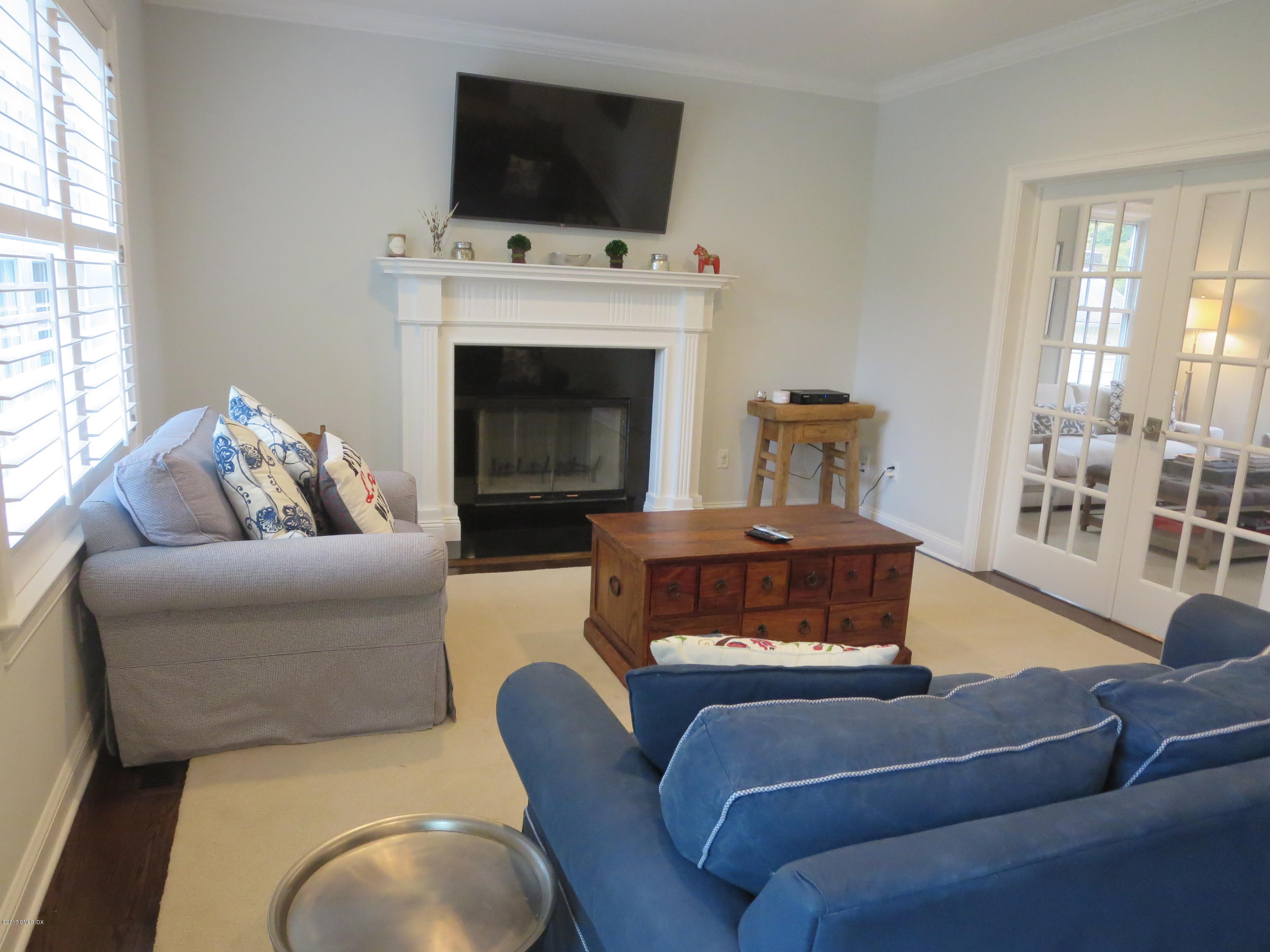 551 River Road Cos Cob, CT 06870 - Photo 17 of 40 a living room with furniture a flat screen tv and a fireplace